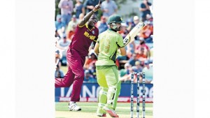 West Indies captain Jason Holder (left) celebrates dismissing Pakistan batsman Ahmed Shehzad during their 2015 Cricket World Cup Group B match in Christchurch on Friday. (PHOTO: AFP)