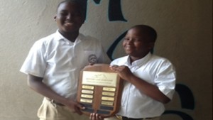          Reycarldo Herbert and Jahromir Evanson with championship shield