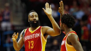 The Rockets' James Harden (left) celebrates with Patrick Beverley after hitting a 3-point shot against the Nuggets.