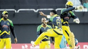 Jamaica Tallawahs wicketkeeper Chadwick Walton (right) celebrates with Krishmar Santokie (#67) after stumping Andre Fletcher of St Lucia Zouks during their Hero CPL T20 game at Sabina Park last night. (