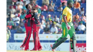 Trinidad and Tobago Red Steel Captain Dwayne Bravo (left) and brother Darren Bravo celebrate one of the wickets against Guyana Amazon Warriors at Warner Park on Saturday. (PHOTO: CPL T20 LTD.2015)