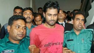 Bangladesh cricketer Shahadat Hossain (center) is led away by Bangladesh police after turning himself in on charges related to abuse.