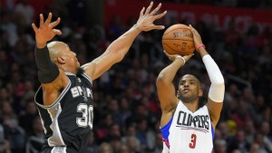 Clippers guard Chris Paul goes for 28 points and 12 assists against David West and the Spurs on Thursday in Los Angeles. The Clippers won 105-86.