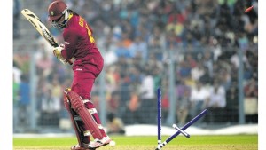 West Indies’ Chris Gayle looks back towards his shattered stumps after his dismissal during a warm-up match between India and West Indies ahead of the World T20 cricket tournament at The Eden Gardens Cricket Stadium in Kolkata, India, yesterday. India won by 45 runs.