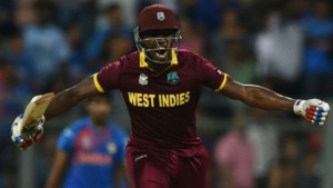 West Indies's Andre Russell celebrates after scoring the winning runs during the World T20 men's semi-final match between India and West Indies at The Wankhede Cricket Stadium in Mumbai on March 31, 2016. (Photo: AFP)