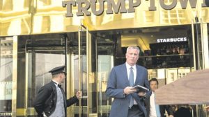 New York City Mayor Bill de Blasio walks out of Trump Tower to speak to the press after his meeting with President-elect Donald Trump, yesterday, in New York City